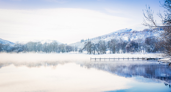 Mist over the water of Loch Earn in the Trossachs, Scotland during winter.