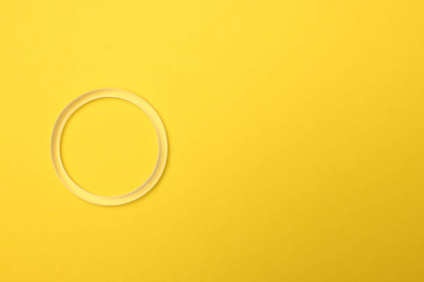 istock Diaphragm vaginal contraceptive ring on yellow background, top view. Space for text 1804434291