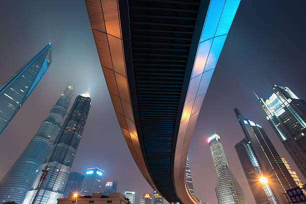 istock pedestrian bridge with shanghai skyline at night 180443648