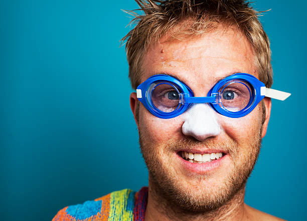 Happy blonde man excited to go swimming stock photo