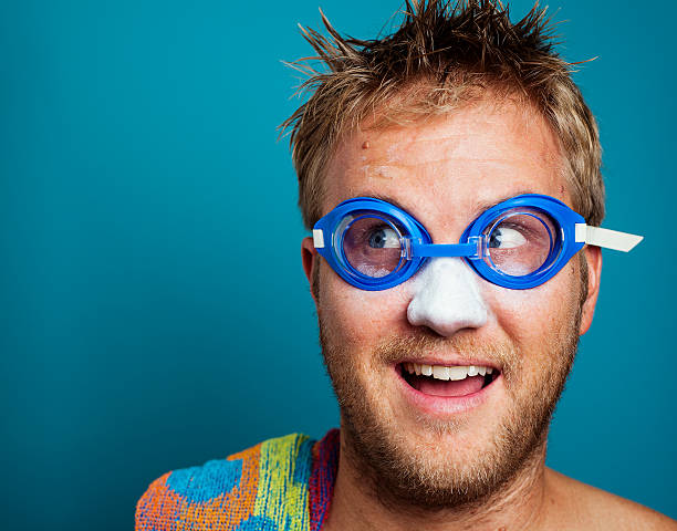 Happy blonde man excited to go swimming stock photo