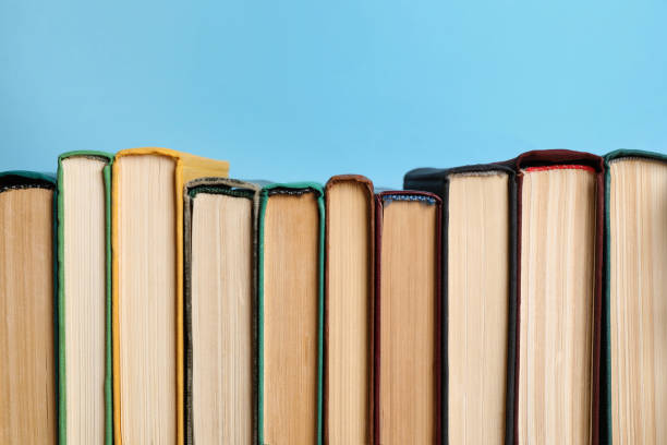 istock Many old books on light blue background, closeup 1804450849