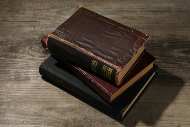 istock Stack of old hardcover books on wooden table 1804451395