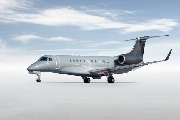 istock Modern business jet isolated on bright background with sky 1804451969