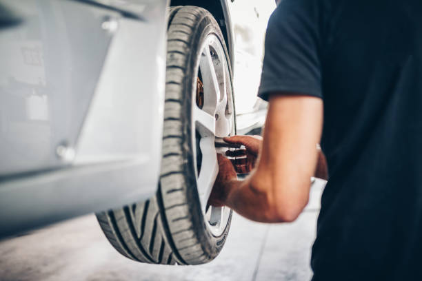 istock Man changing a car wheel in tire fitting 1804468688