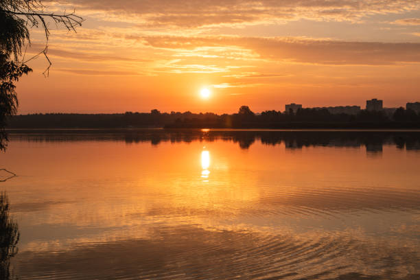 istock Sunrise sun shining on lake mirror water surface 1804498820
