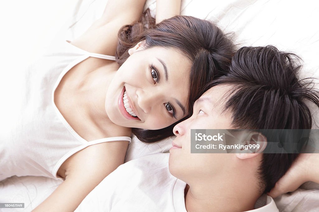 couple happy smile looking to each other in bed young lovely couple lying in a bed, happy smile looking to each other, top view, asian people Asian and Indian Ethnicities Stock Photo