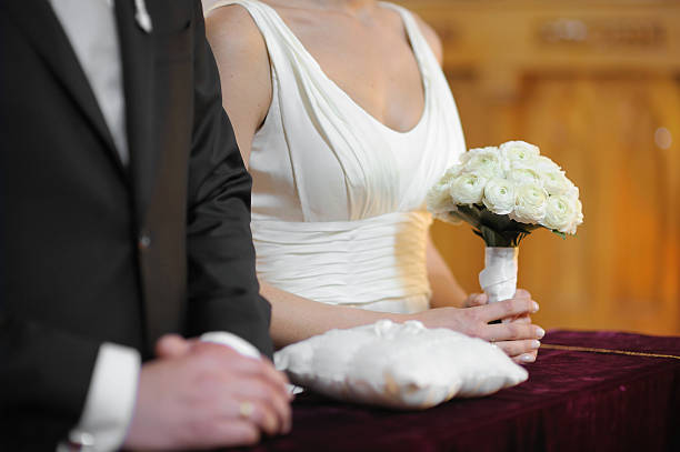 istock Bride holding white wedding flowers bouquet 180454523