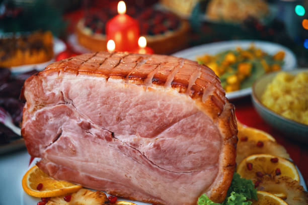 istock Christmas Dinner with Baked Glazed Ham and Various Vegetables 1804549948