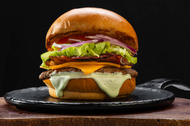 istock Traditional hamburger, bread, burger meat, melted cheese, lettuce, tomato, mayonnaise and onion. 1804550507
