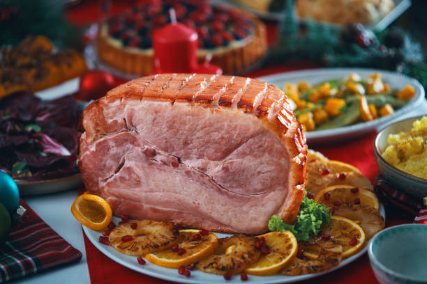 istock Christmas Dinner with Baked Glazed Ham and Various Vegetables 1804551038