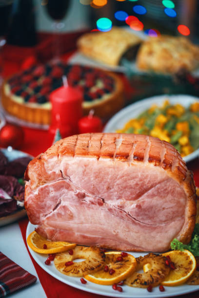 istock Christmas Dinner with Baked Glazed Ham and Various Vegetables 1804551044