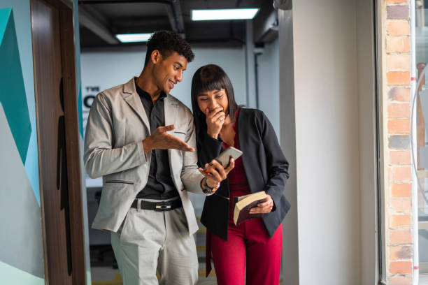 istock coworkers looking at congratulations email for their good work 1804551069