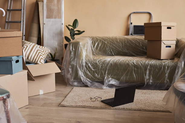 istock New comfortable couch wrapped into cellophane standing on the floor 1804551594