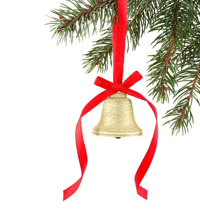 Christmas bell with red bow hanging on fir tree branch against white background