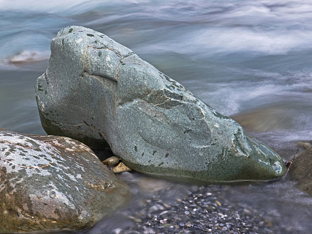 istock Green rock and flowing water 180455609
