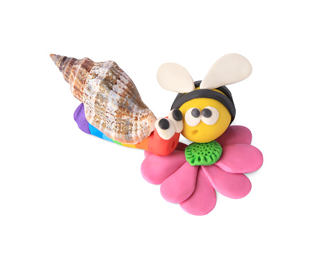 Bee with flower and snail made from plasticine on white background. Children's handmade ideas