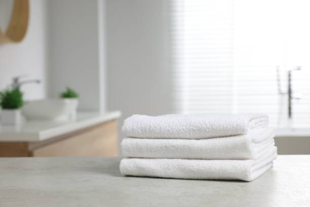 istock Stack of white towels on table in bathroom. Space for text 1804558688