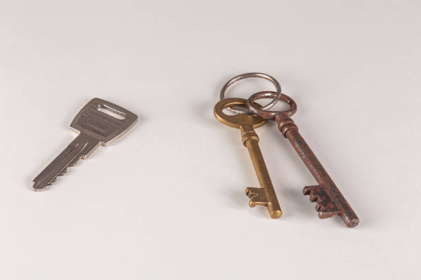 istock Two aged and one new keys on a white surface. Close up. 1804562688