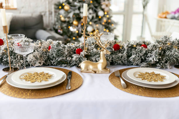 istock Table served for Christmas dinner in living room, close-up view, table setting, Christmas decoration 1804564918