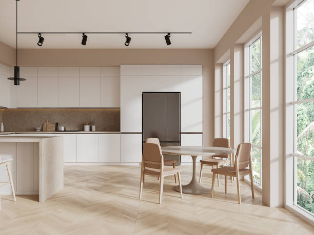 istock Beige hotel kitchen interior with eating table, bar island and panoramic window 1804571530