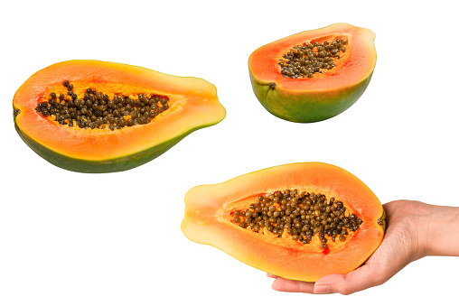 Papaya fruit isolated on a white background in woman hands. Tropical fruit. Half papaya.
