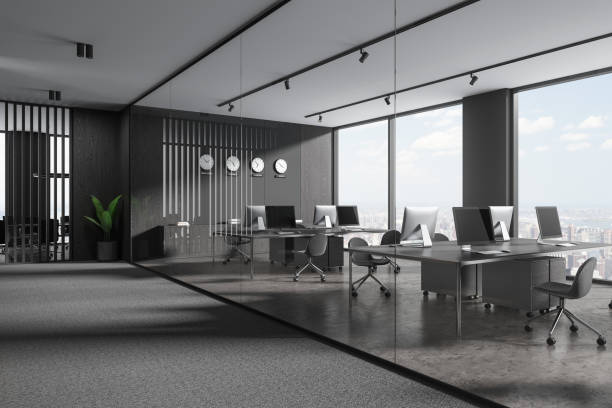 istock Gray and wooden open space office corner with clocks 1804576460