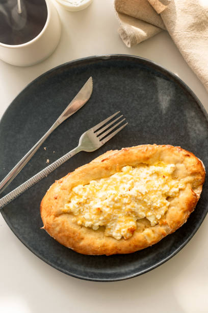 istock traditional Georgian cuisine.  Open pie with mozzarella cheese. Ajara khachapuri 1804589059