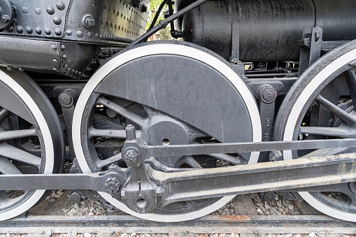 detail of the red and white metallic wheels of the old black one\ntrain steam locomotive