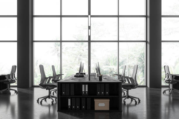 istock Modern coworking interior with pc monitors and shelf, panoramic window 1804603024