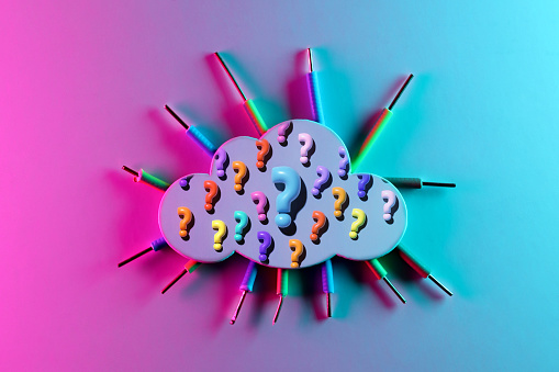 Colorful question marks on cloud-shaped paper