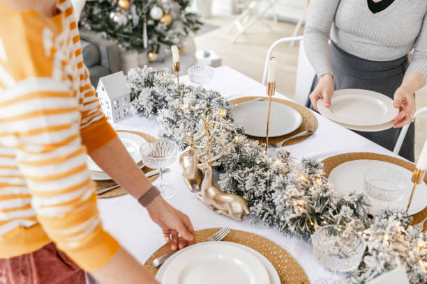 istock Women arranging dining table with christmas decoration 1804620003