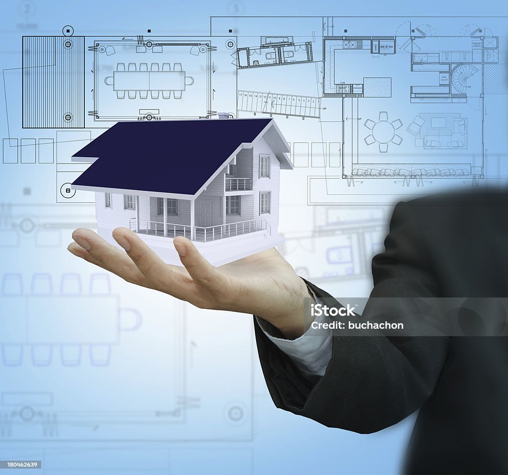 Businessman present house model and plan on touch screen Adult Stock Photo