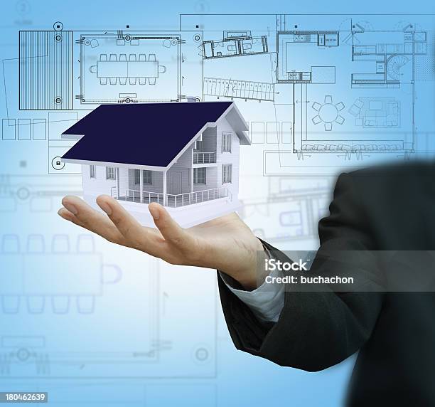 Businessman Present House Model And Plan On Touch Screen Stock Photo - Download Image Now