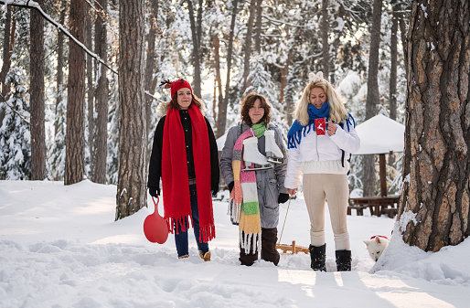 Young happy family on winter vacation having fun on a snowy mountain