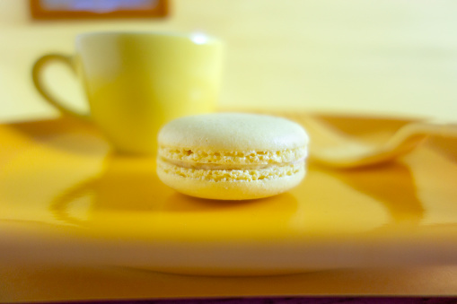 Yellow macaron in a yellow set up with yellow crockery