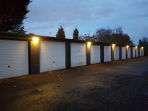 A row of white garage doors at dusk in Glasgow Scotland UK