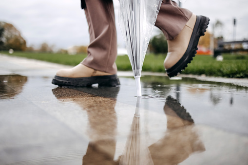 Woman going to work on rainy day wearing boots