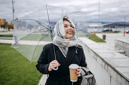 Young woman on walking outside on rainy day