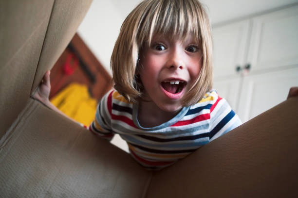 istock Happy boy opening delivery box at home 1804678049