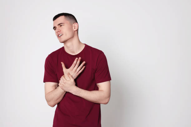 istock Man suffering from pain in his hand on light background, space for text. Arthritis symptoms 1804679118