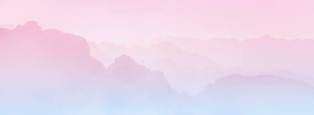 istock Layered mountain silhouettes with pink to blue gradient. Long panoramic wallpaper. 1804680195