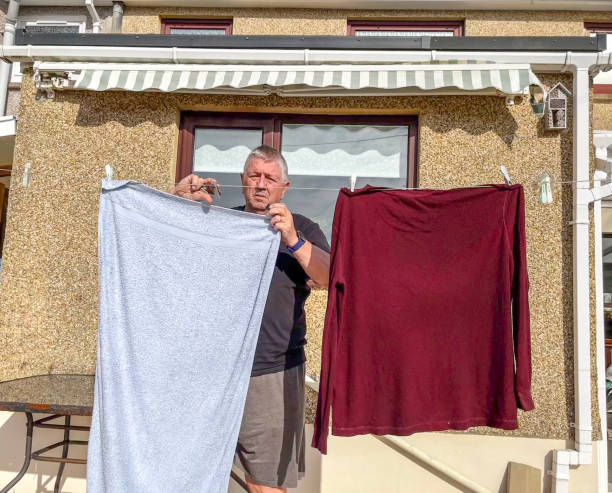 istock Senior Caucasian man pegging out washing 1804682428