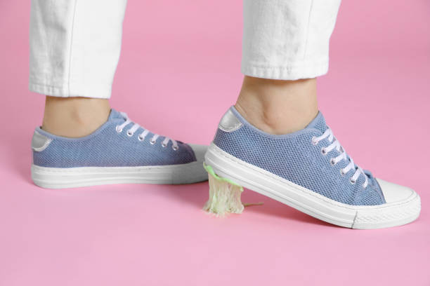 istock Person stepping into chewing gum on pink background, closeup 1804685581