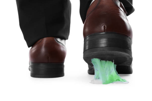 man stepping into chewing gum on white background, closeup - adhering imagens e fotografias de stock