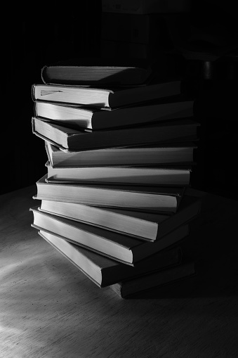 stack of books close up, black and white, reading, education, knowledge concept.