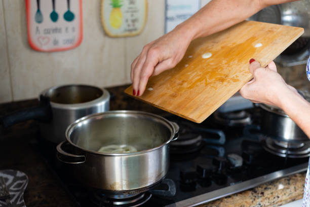 istock Onions being placed in the pan. 1804716778