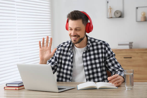 istock Man studying on laptop at home. Online translation course 1804718405