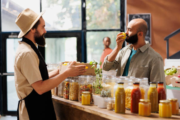 istock Customer smelling lemon at local shop 1804722119