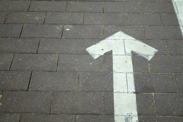 Directional arrow straight ahead on the road.